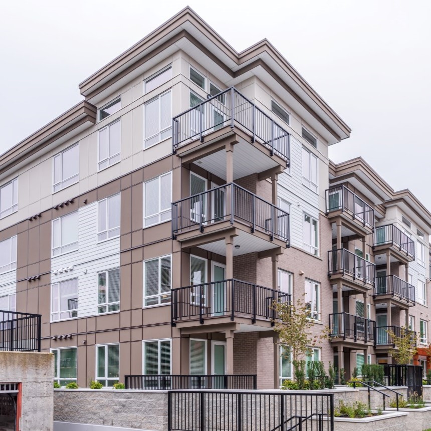 Low-angle view of modern brown and tannish colored apartment buildings