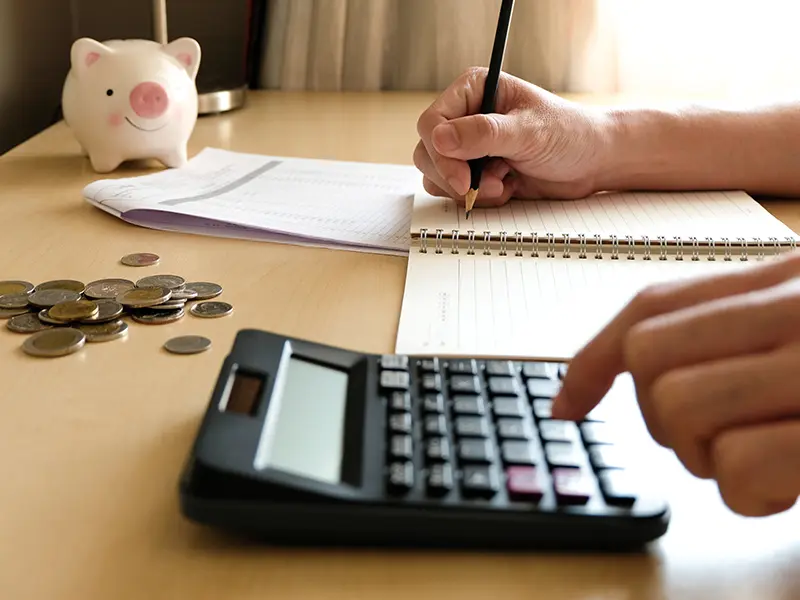 Person using calculator on desk