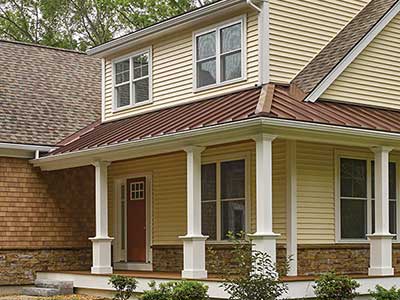 Large, mid-class home with beige CertainTeed siding