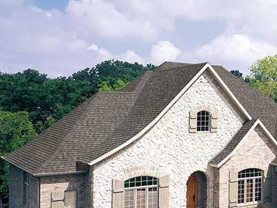 Close up of a residential roof with brown shingles by Owens Corning