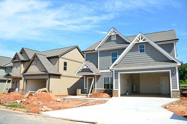 Newly constructed homes in a neighborhood with siding and shingle roofs installed